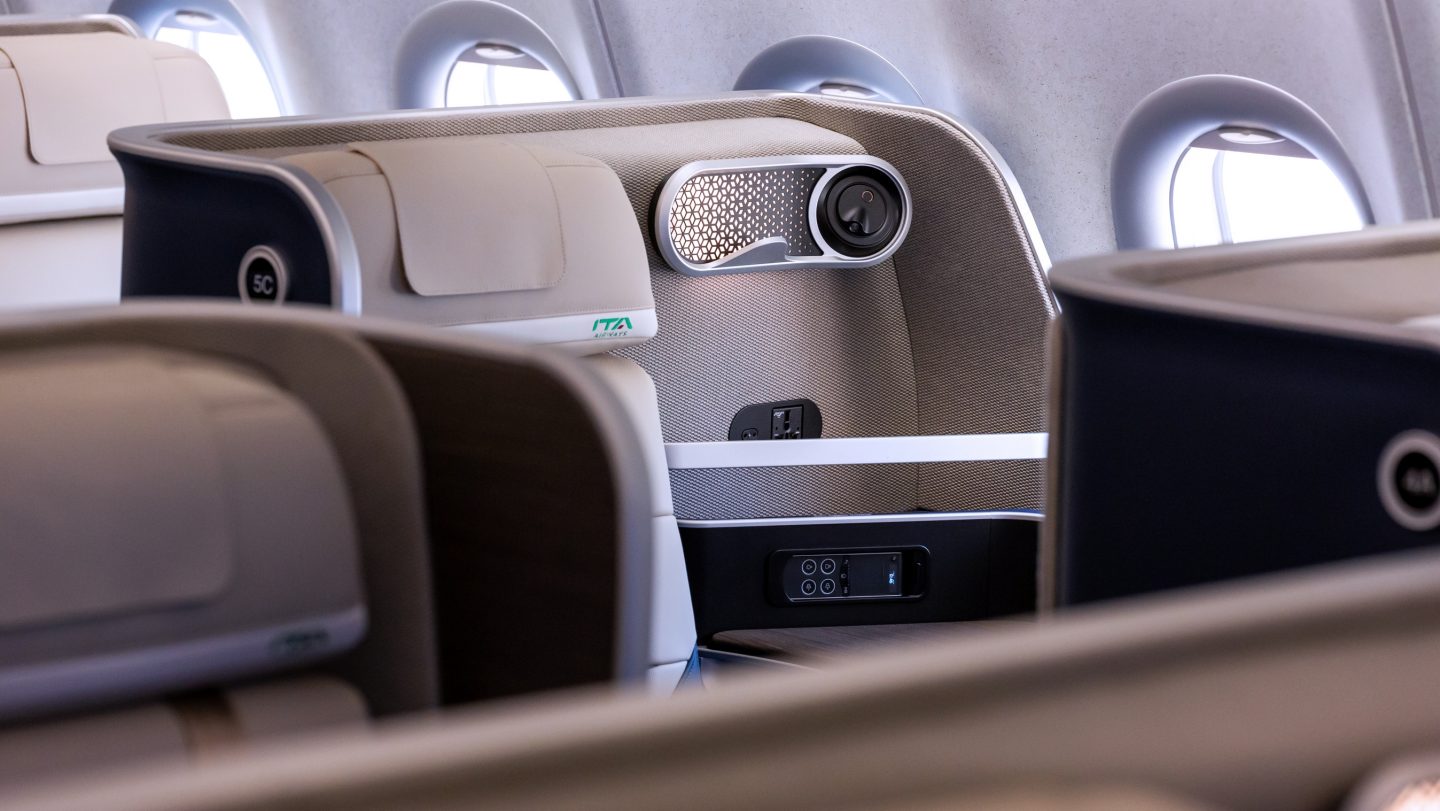 A cream headrest of a Business Class seat.