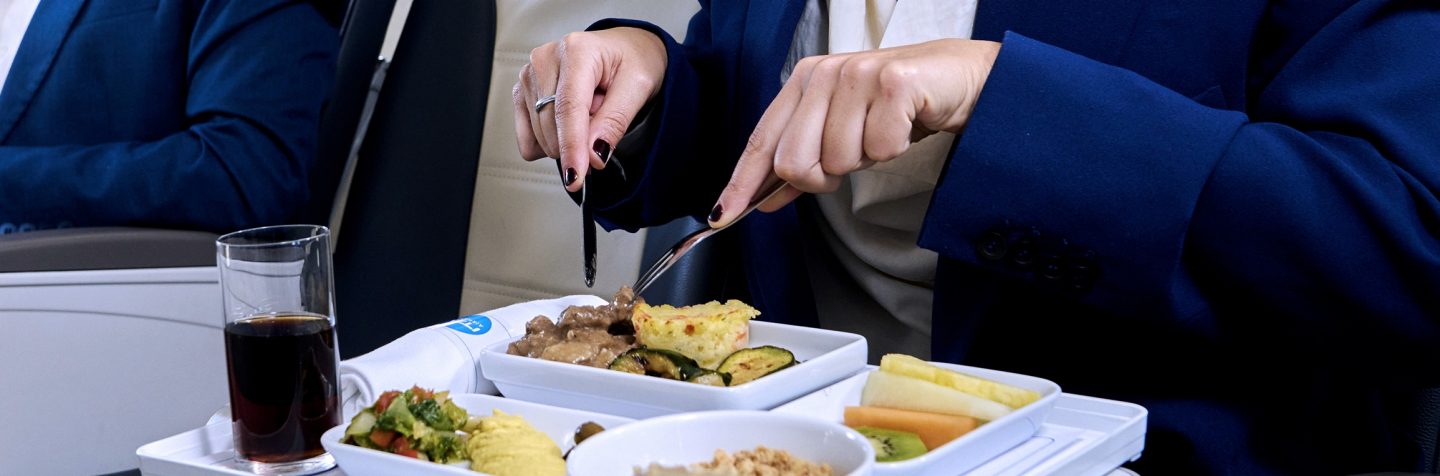 Passengers eating a meal served in Business Class.
