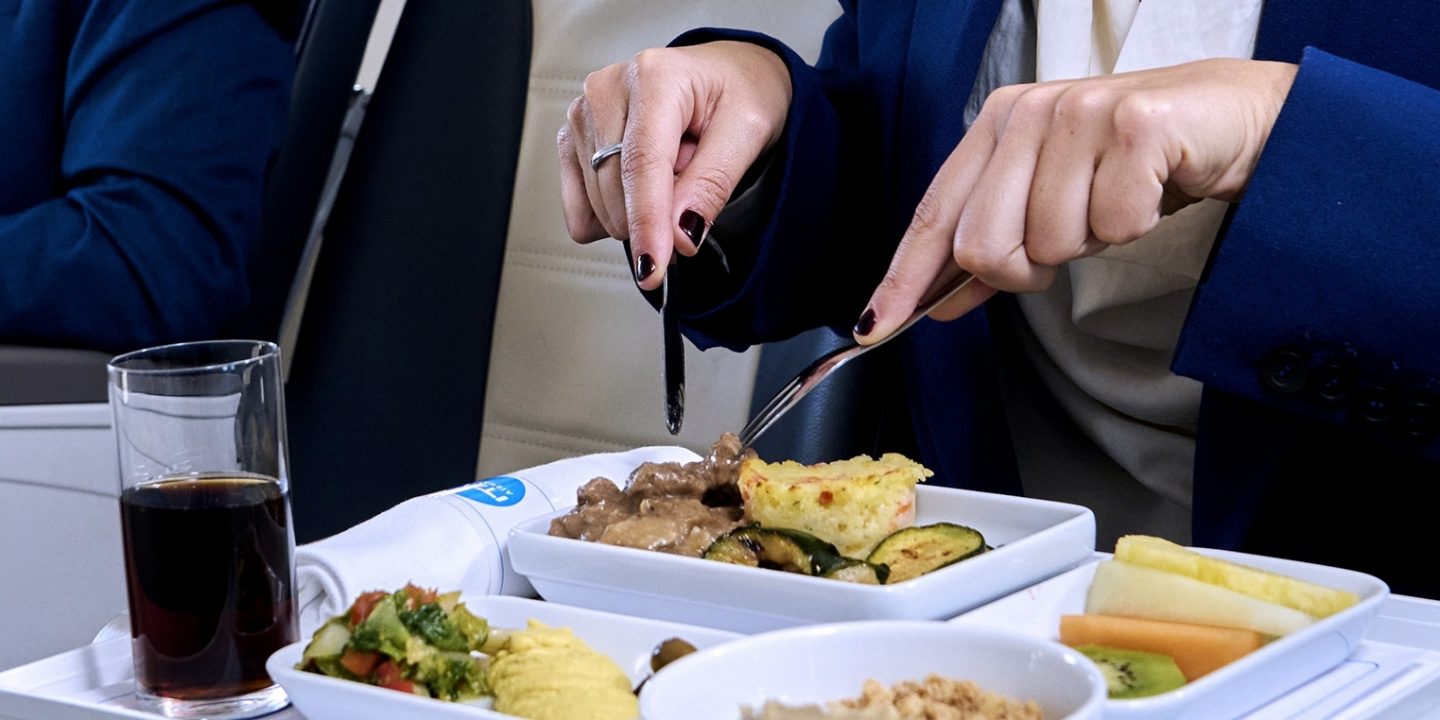 Passengers eating a meal served in Business Class.