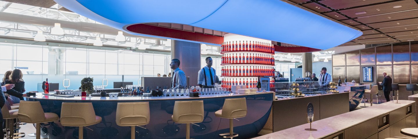 Lounge bar area with a counter, stools, and overhead lighting.