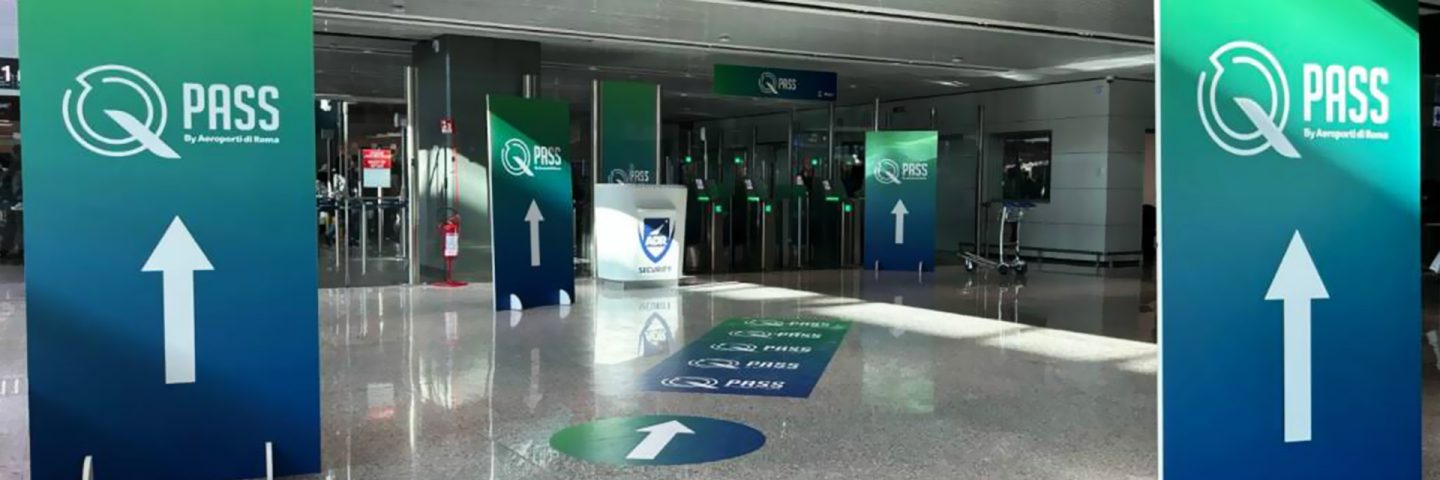 Several signs indicating the entrance to QPass Services.