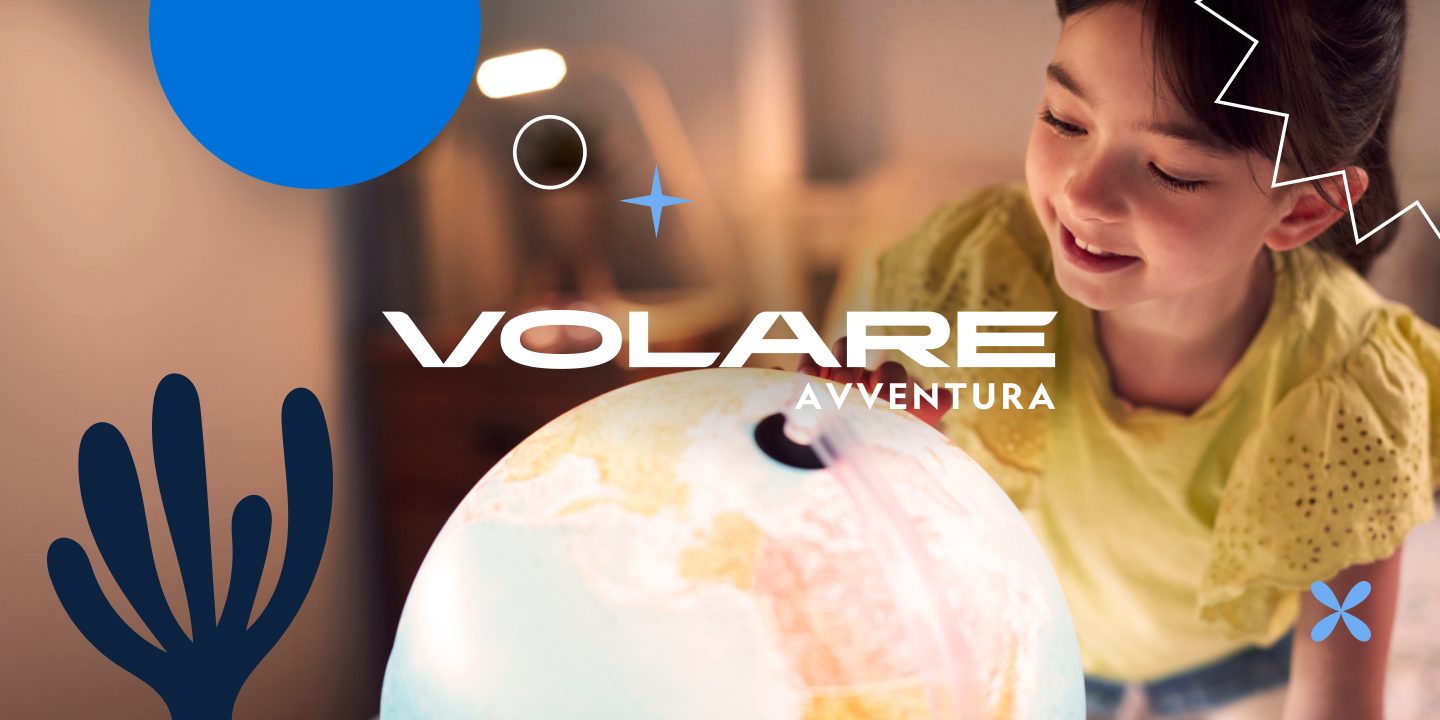 Little girl with a light-up globe and the Volare Avventura logo