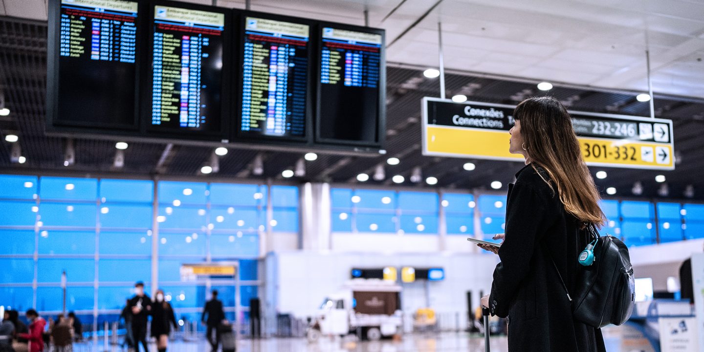 A woman checking flight schedules at the airport.