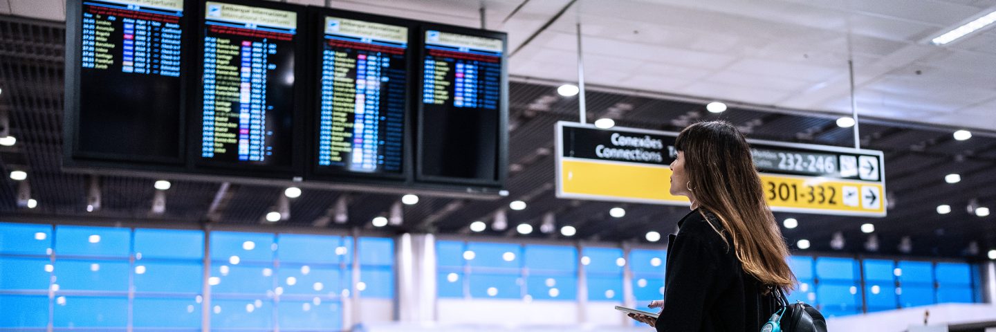 A woman checking flight times in an airport. 
