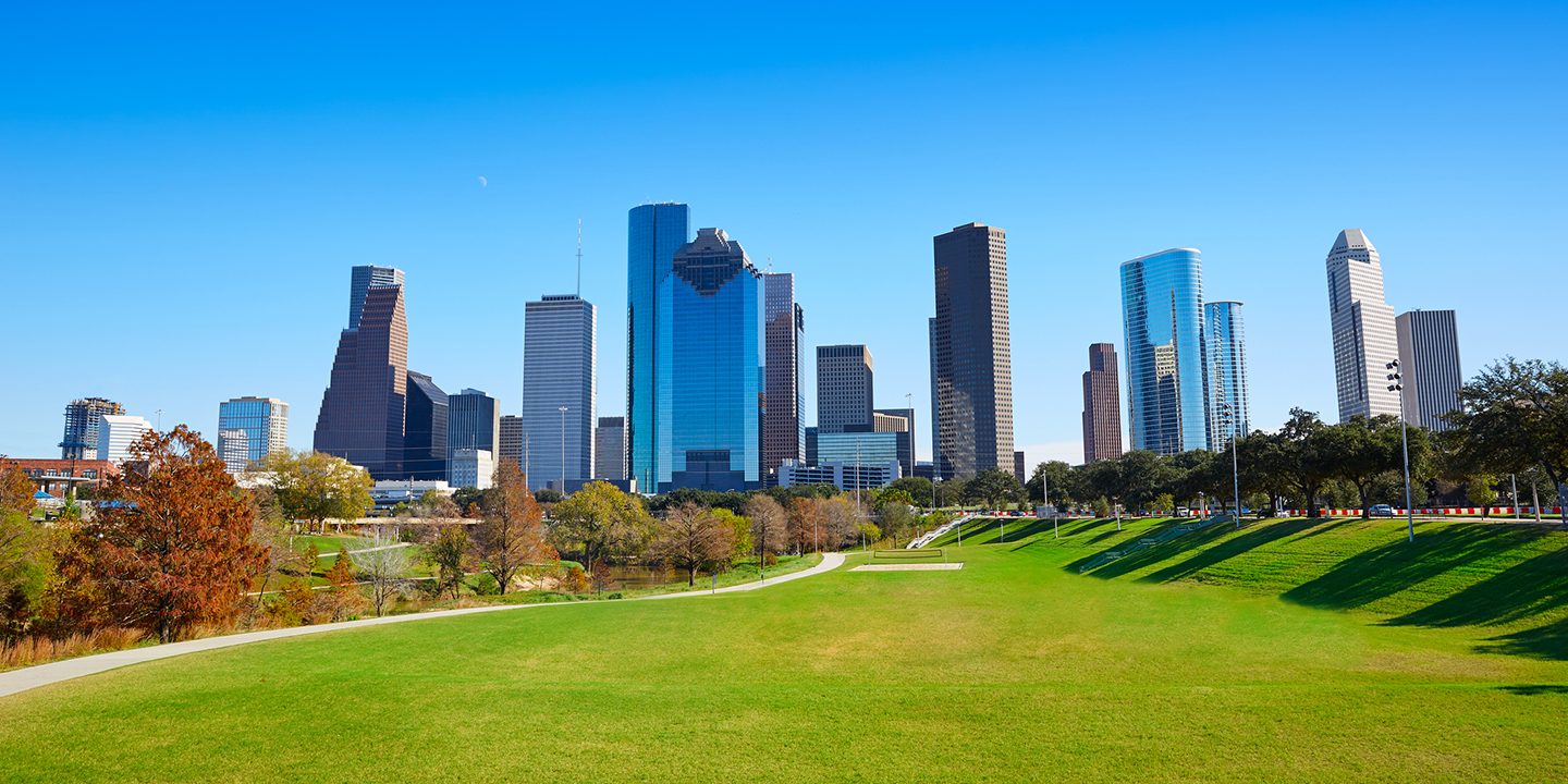 Houston skyline with skyscrapers and a large green park in the foreground